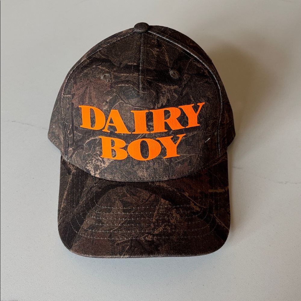 Camo Trucker hat with Orange 'Dairy Boy' Text